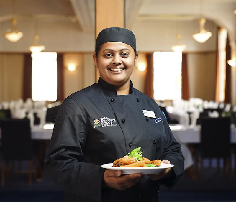 female employee holding vegetables
