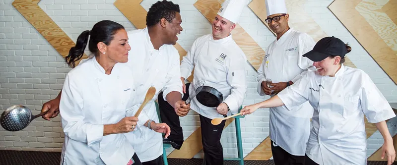 A group of chef is joking
