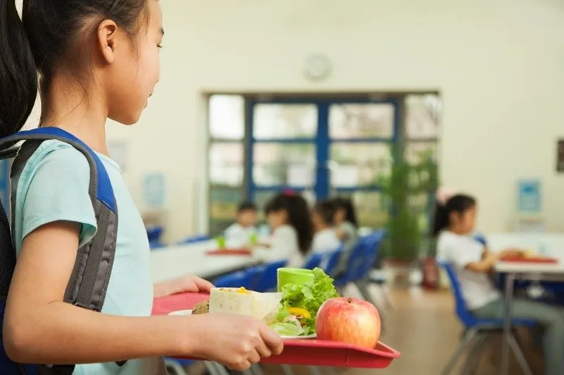 a kid holding a food plate