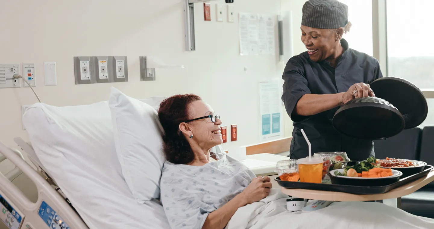 Female staff bring food to patients