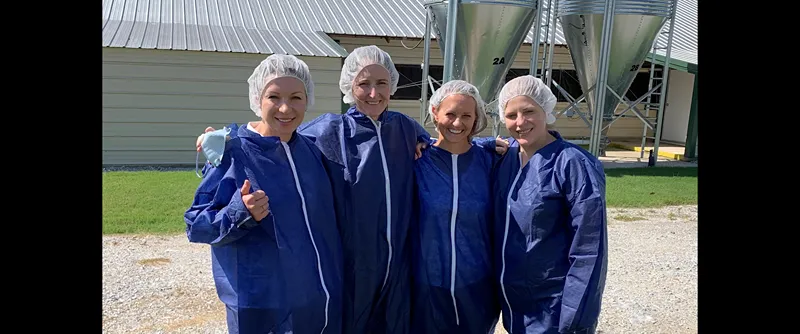 female workers standing in front of a factory