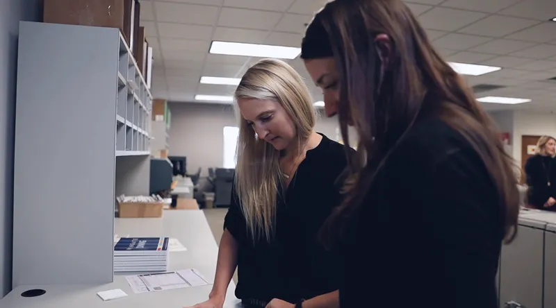 2 women looking at a paper