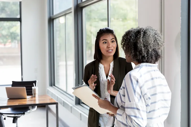 2 women talking about a report
