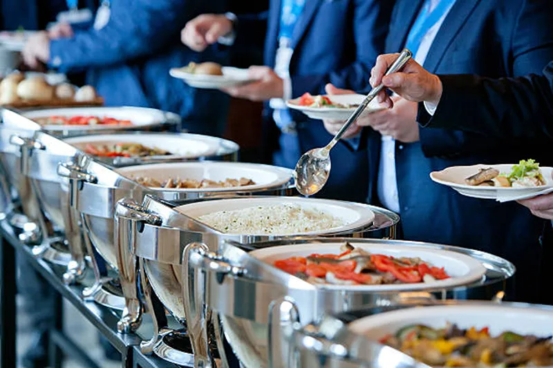 people choosing food in a buffet